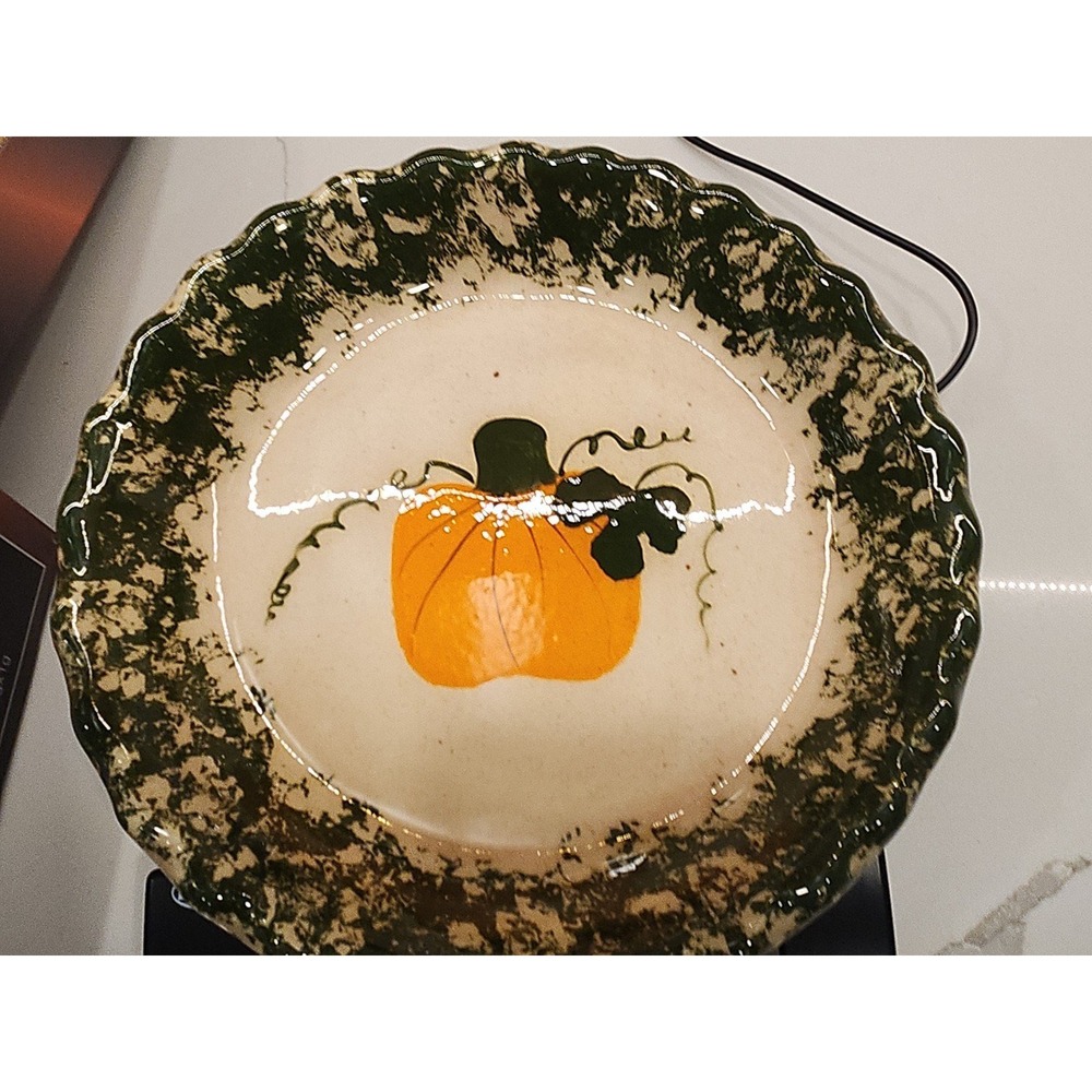 Green spongeware pottery pie plate with pumpkin‎ detail